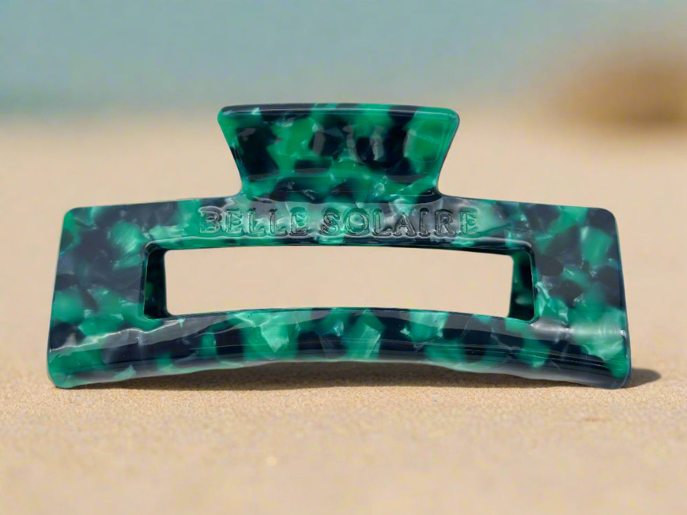 Front-facing view of the Emerald Grove claw clip, showcasing its rectangular shape and vibrant green and teal hue colors.