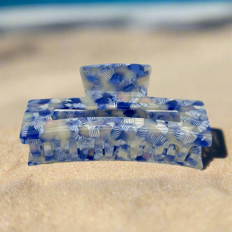 Detailed shot of the Indigo Bloom clip, focusing on the grip claws and the intricate marbled blue-white design.