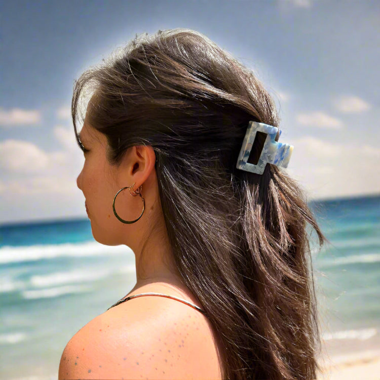 Model wearing the Indigo Bloom clip outdoors, styled in long hair for a chic and nature-inspired everyday look.