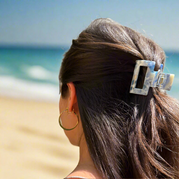 Model wearing the Indigo Bloom clip outdoors, styled in long hair for a chic and nature-inspired everyday look.