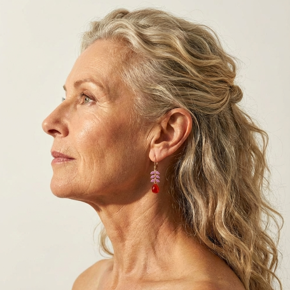 Model wearing Ella gold vermeil earrings with enameled leaf design and Red Onyx gemstone drop.