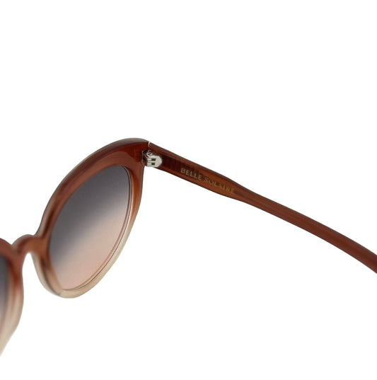 Close-up of the inside of rose cat-eye sunglasses showing the logo on white background