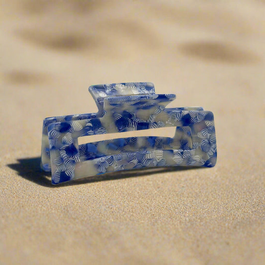 Indigo Bloom hair claw clip featuring a floral-inspired blue and white pattern with translucent accents