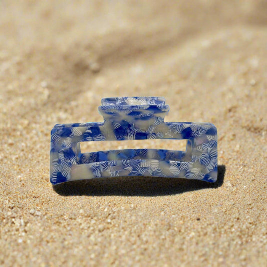 Frontal view of the Indigo Bloom claw clip, highlighting its curved rectangular design and layered petal-like pattern.