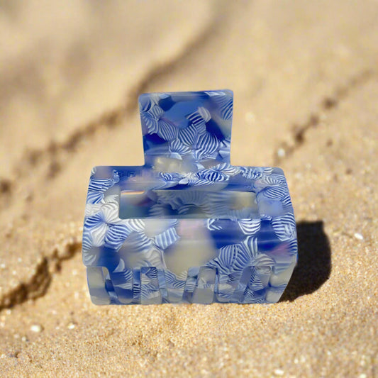 Detailed shot of the Indigo Bloom clip from below, focusing on the grip claws and the intricate marbled blue-white design.