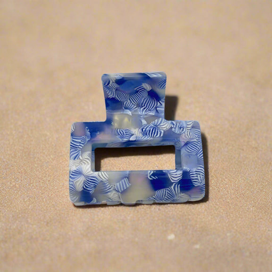 Frontal view of the Indigo Bloom claw clip, highlighting its curved rectangular design and layered petal-like pattern.
