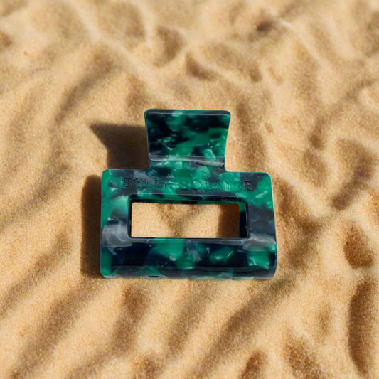 Front-facing view of the Emerald Grove claw clip, showcasing its rectangular shape and vibrant green and teal hue colors.