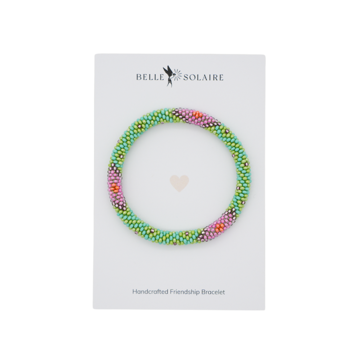 A handmade friendship bracelet made of small multicolored  glass beads, displayed on a white card from the brand Belle Solaire.