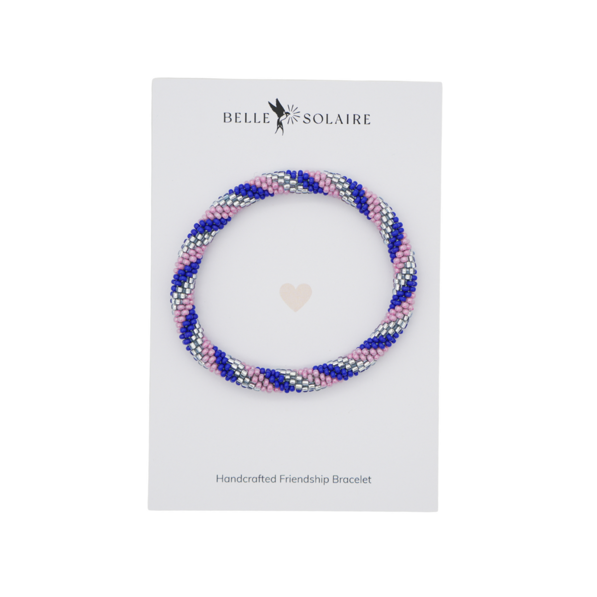 A handmade friendship bracelet made of blue, lilac, and silver glass beads, displayed on a white card from the brand Belle Solaire.