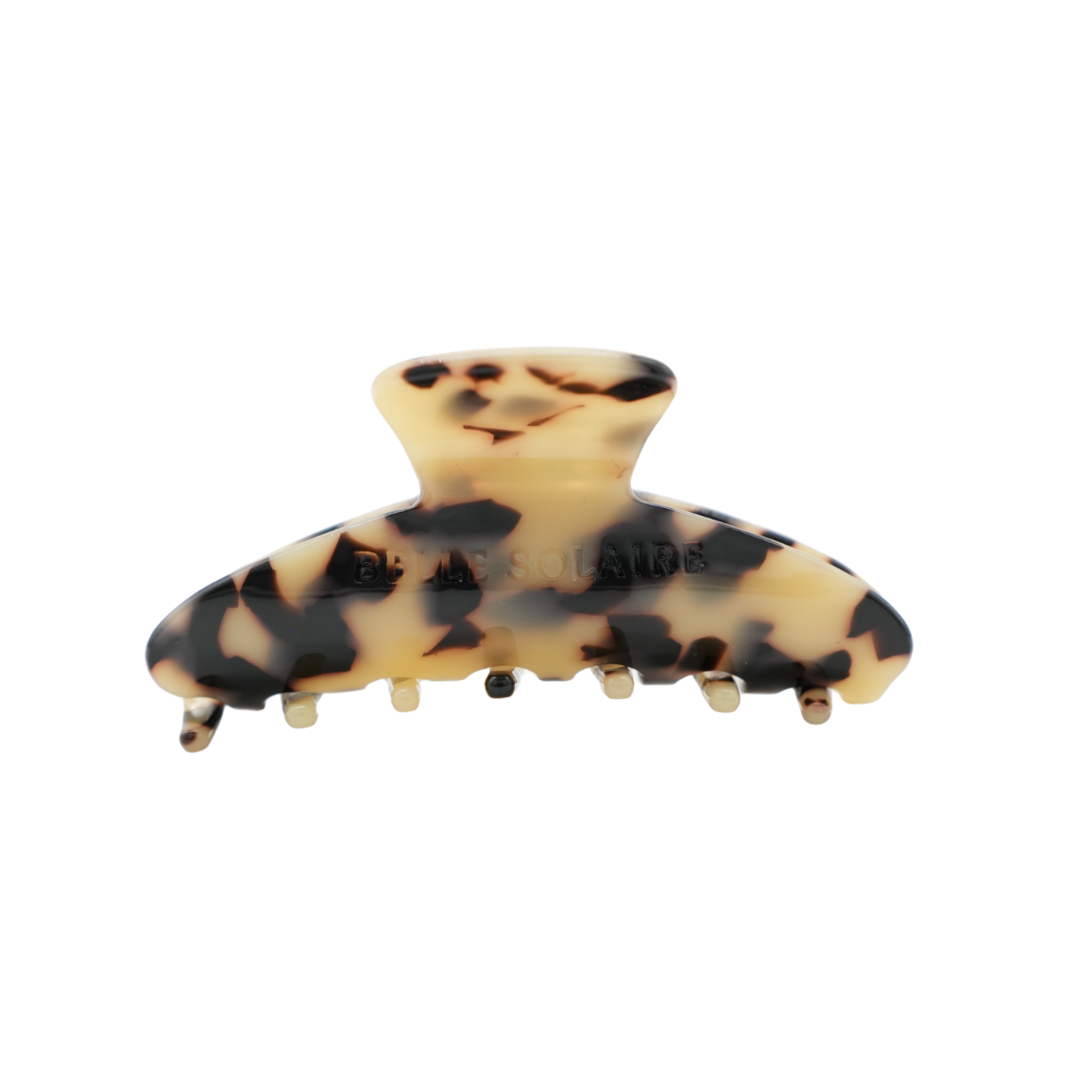 A tortoiseshell hair claw clip with a cream and black pattern made from cellulose acetate, shown against a plain white background.