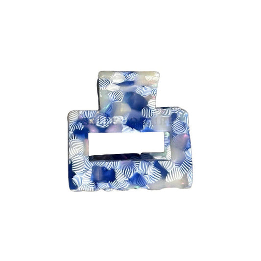 Small Indigo Bloom hair claw clip with soft white and deep indigo pattern, made from cellulose acetate, front view on a white background.