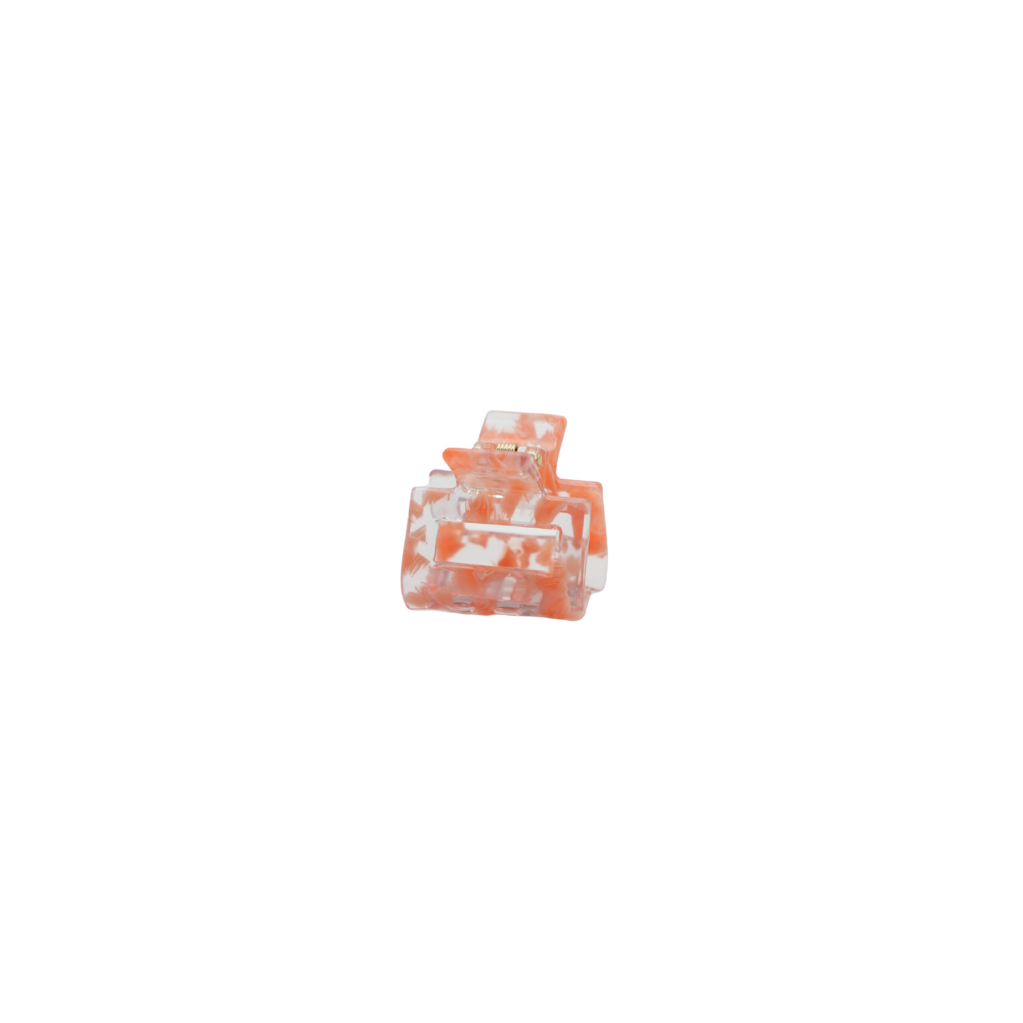 A small translucent peach color hair claw clip made from plant based cellulose acetate, isolated on a solid white background.